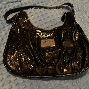 Black patent leather guess purse.